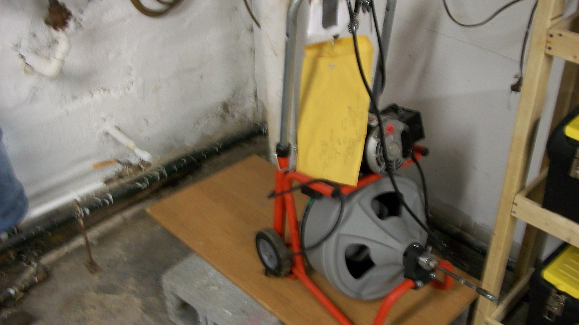 Heavy-duty drain snake drum machine on a plumbing job
