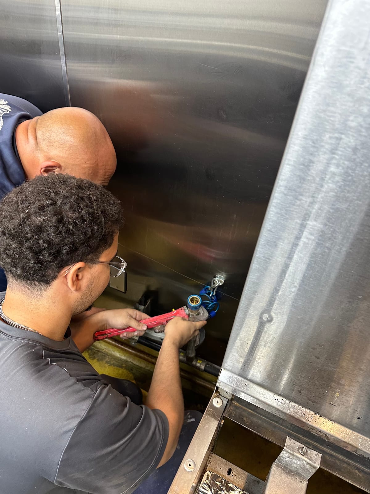 Miami Dade Plumbing crew on a commercial tank job